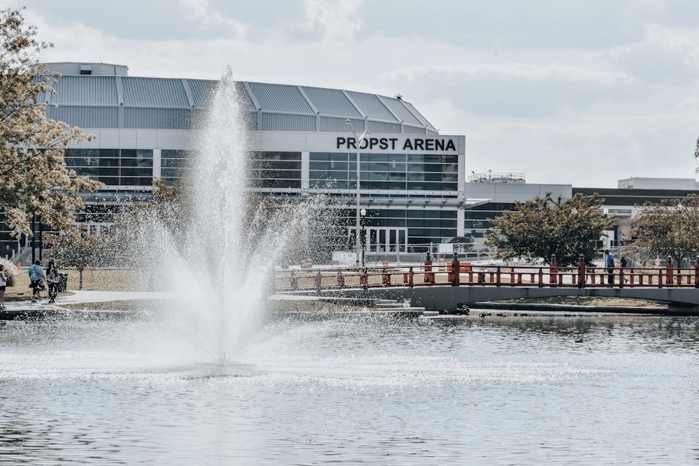 a water fountain in front of a large building