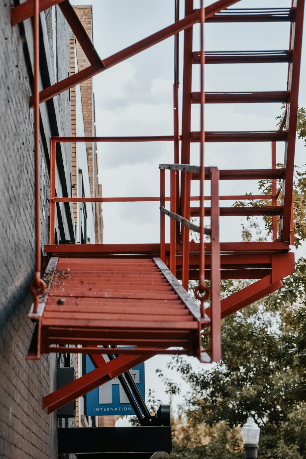 a red metal staircase going up the side of a building