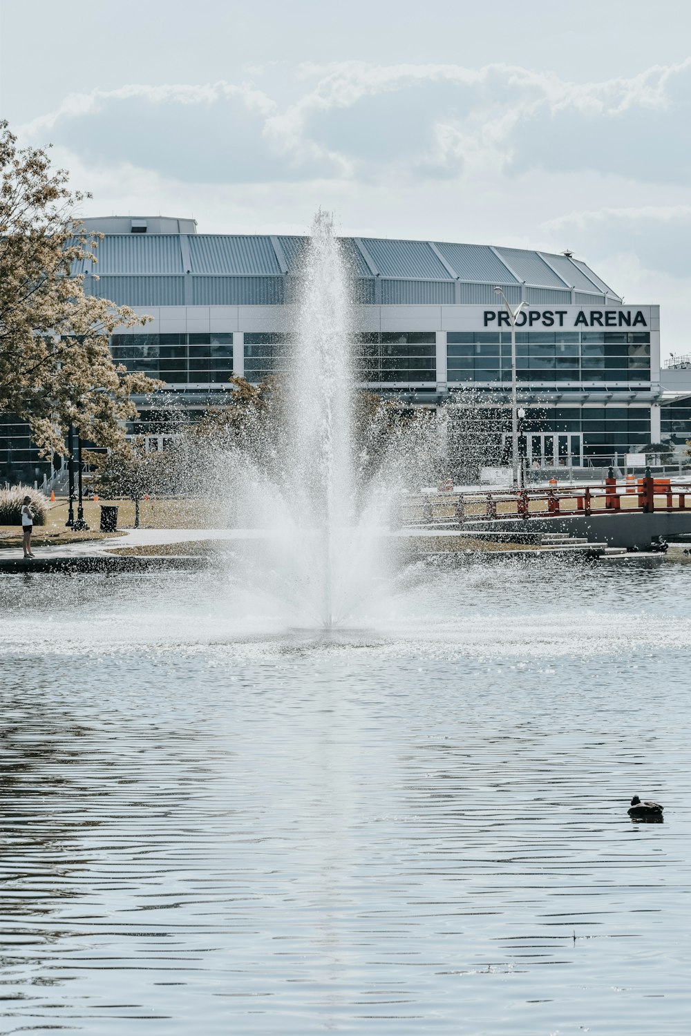 a water fountain in front of a large building