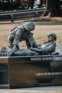 a statue of a man laying on top of a man laying on the ground