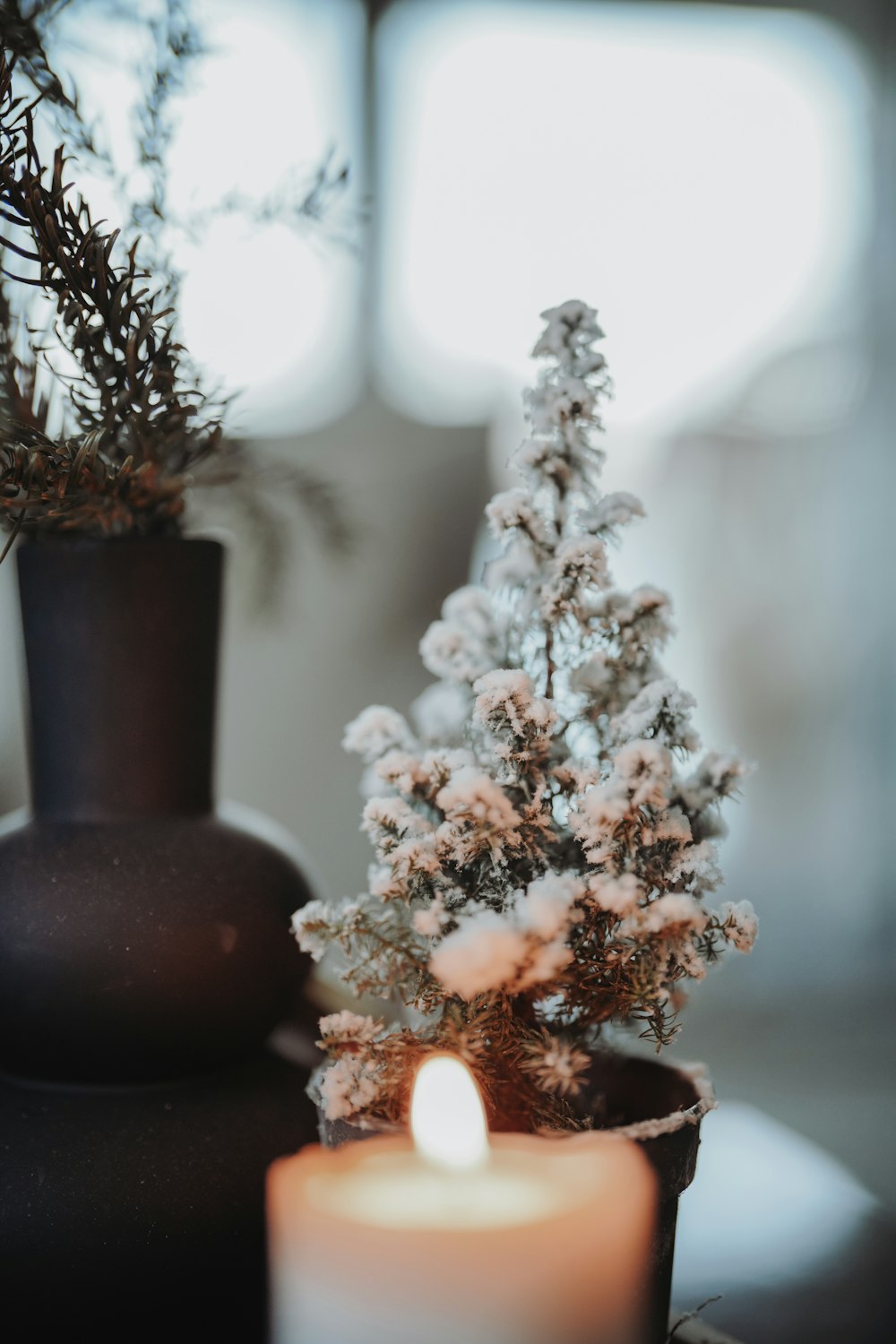 a candle and a vase on a table