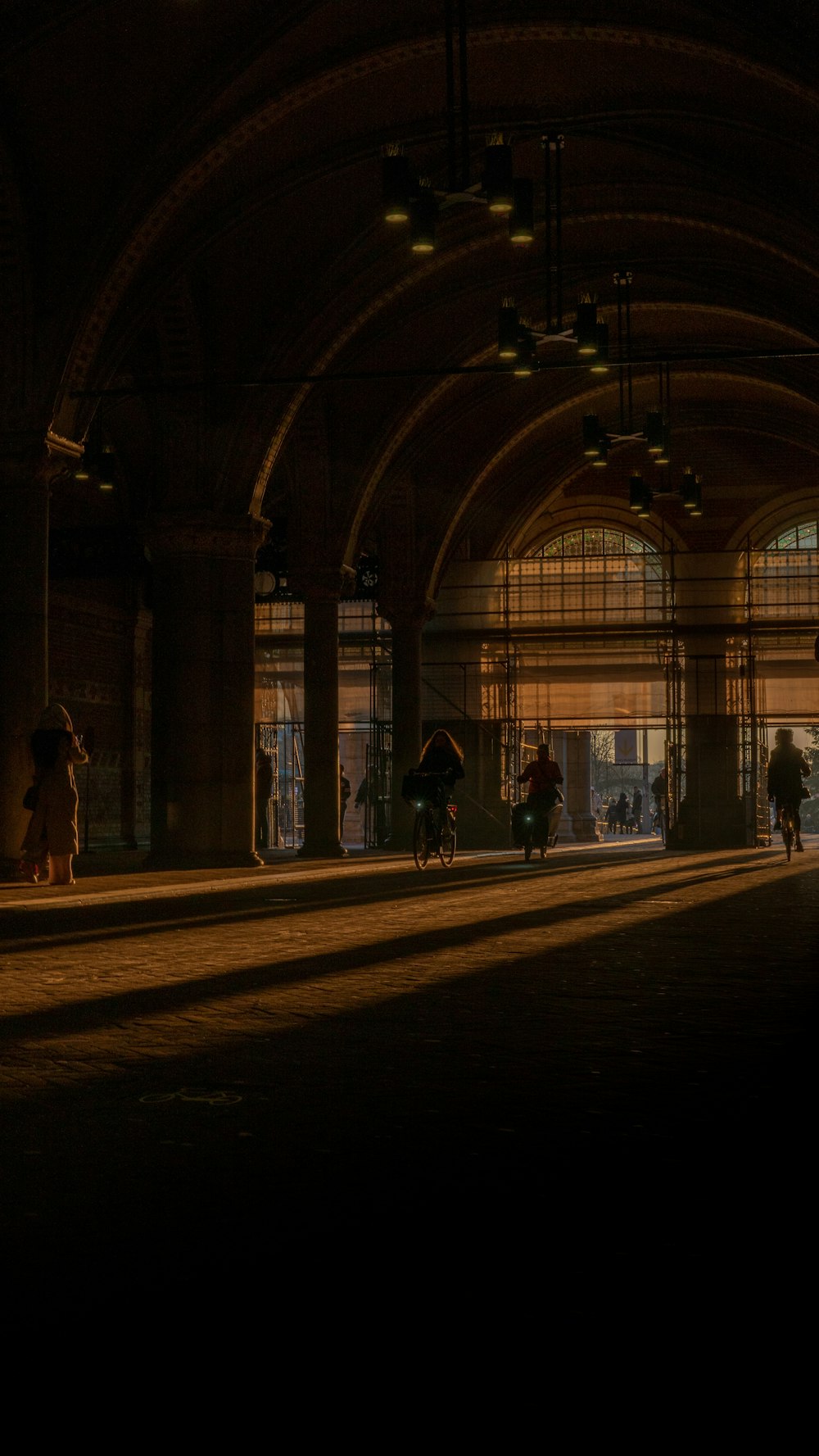 a group of people walking through a train station