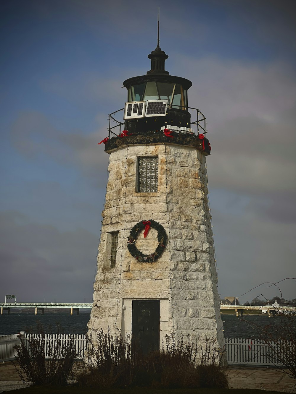a light house with a wreath on top of it
