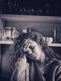 A caring middle-aged woman thoughtfully taking an online burnout quiz at home.