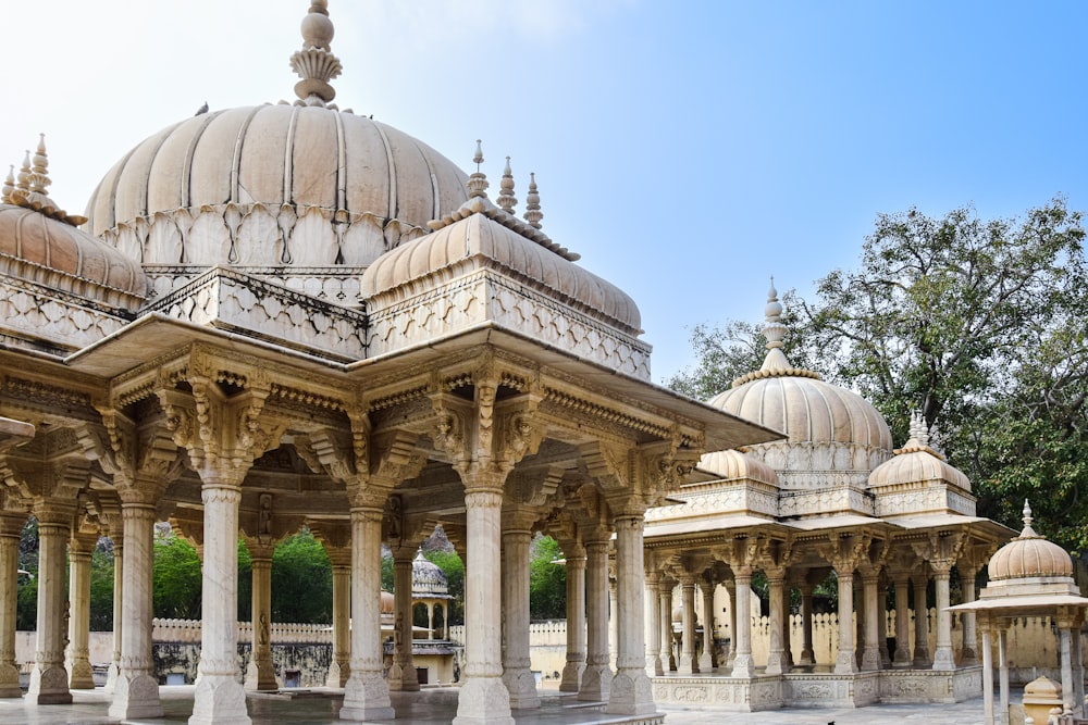 a large white building with many pillars and domes