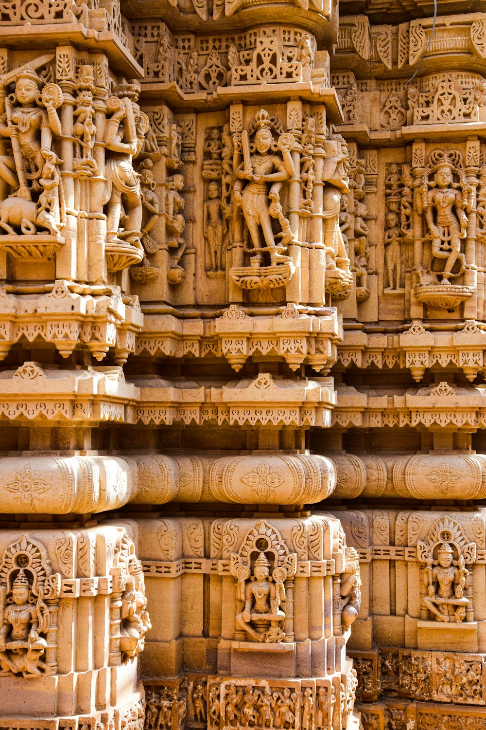 a close up of a wall with carvings on it