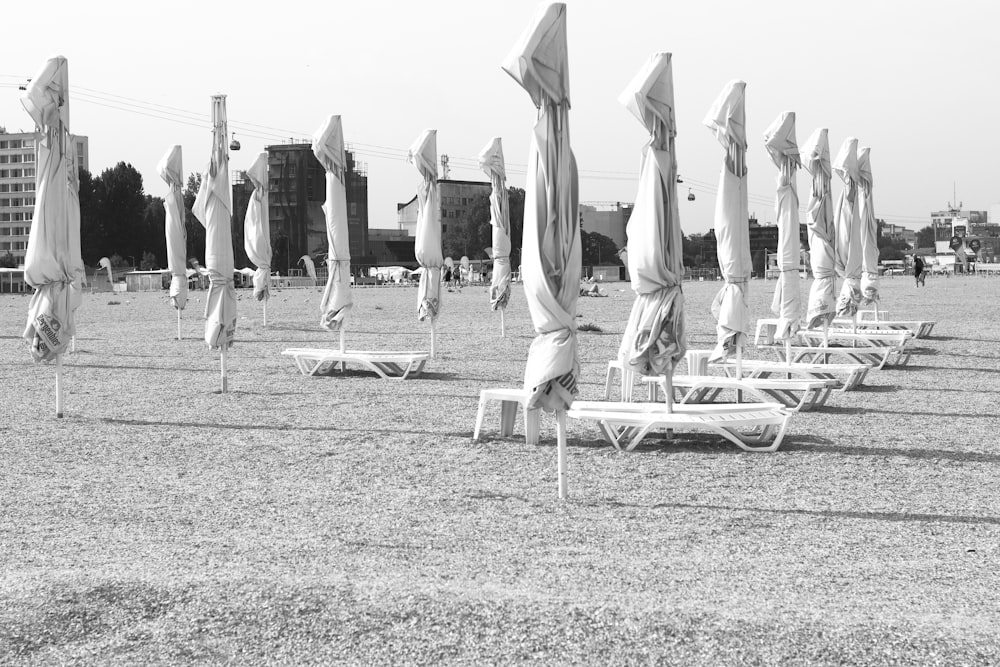 a row of beach chairs sitting on top of a sandy beach