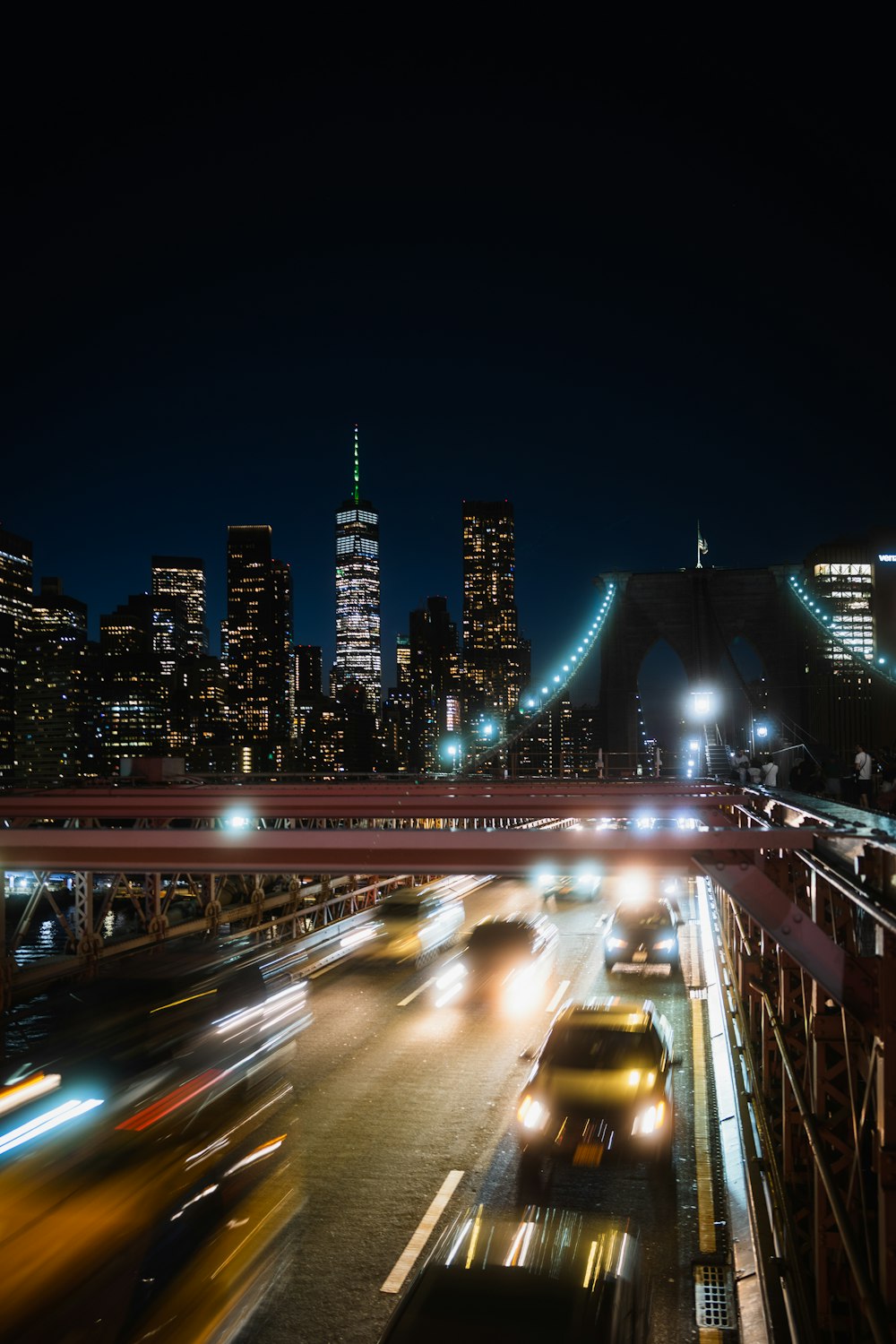 a view of a city at night from a bridge