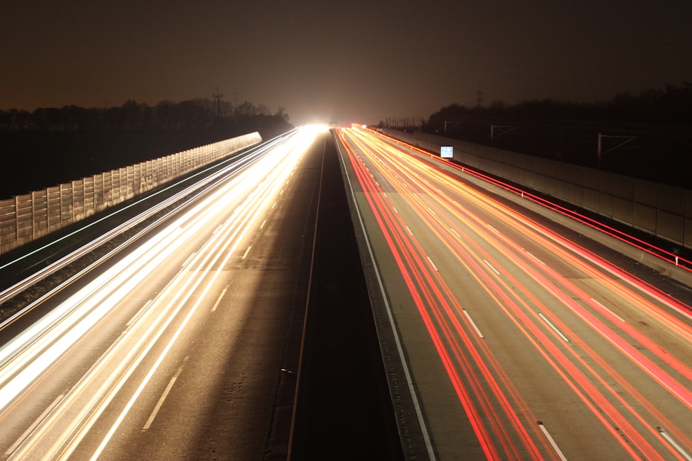 a long exposure photo of a highway at night