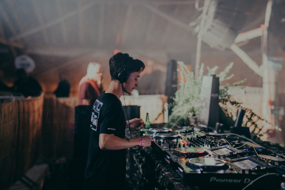 a dj mixing music in a tent at a party