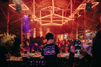 a person standing in front of a dj booth