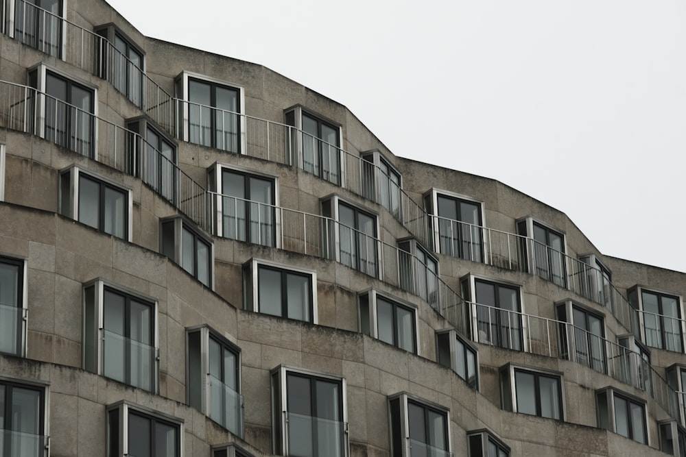 a tall building with lots of windows and balconies