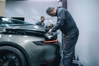 a man working on a car in a garage