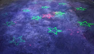 Floating fashion accessories with neon outlines against a dark starry background.