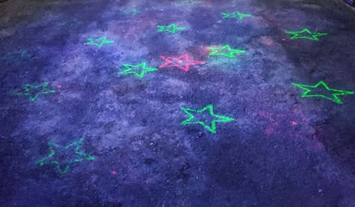 Animated stars gently floating across a dark green and black galaxy backdrop.