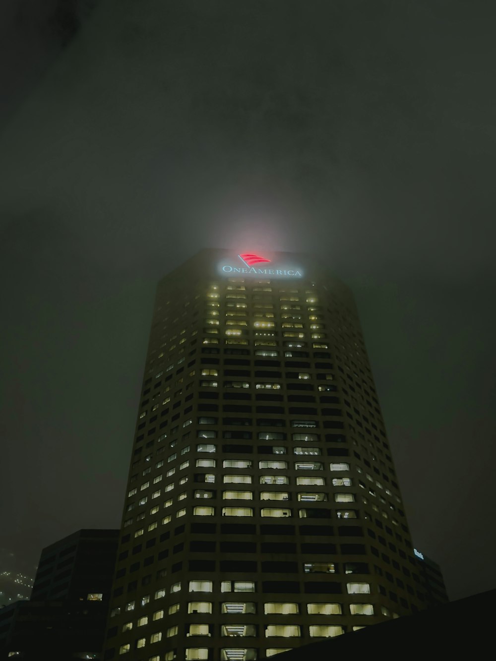 a very tall building with a red light on top of it