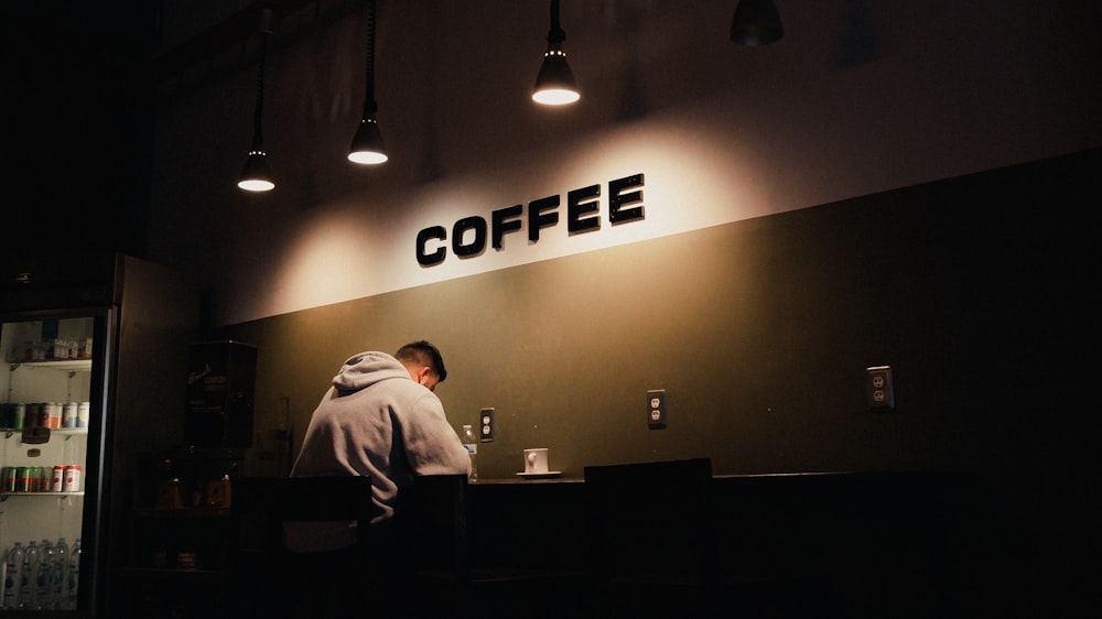 a person sitting at a counter in a coffee shop