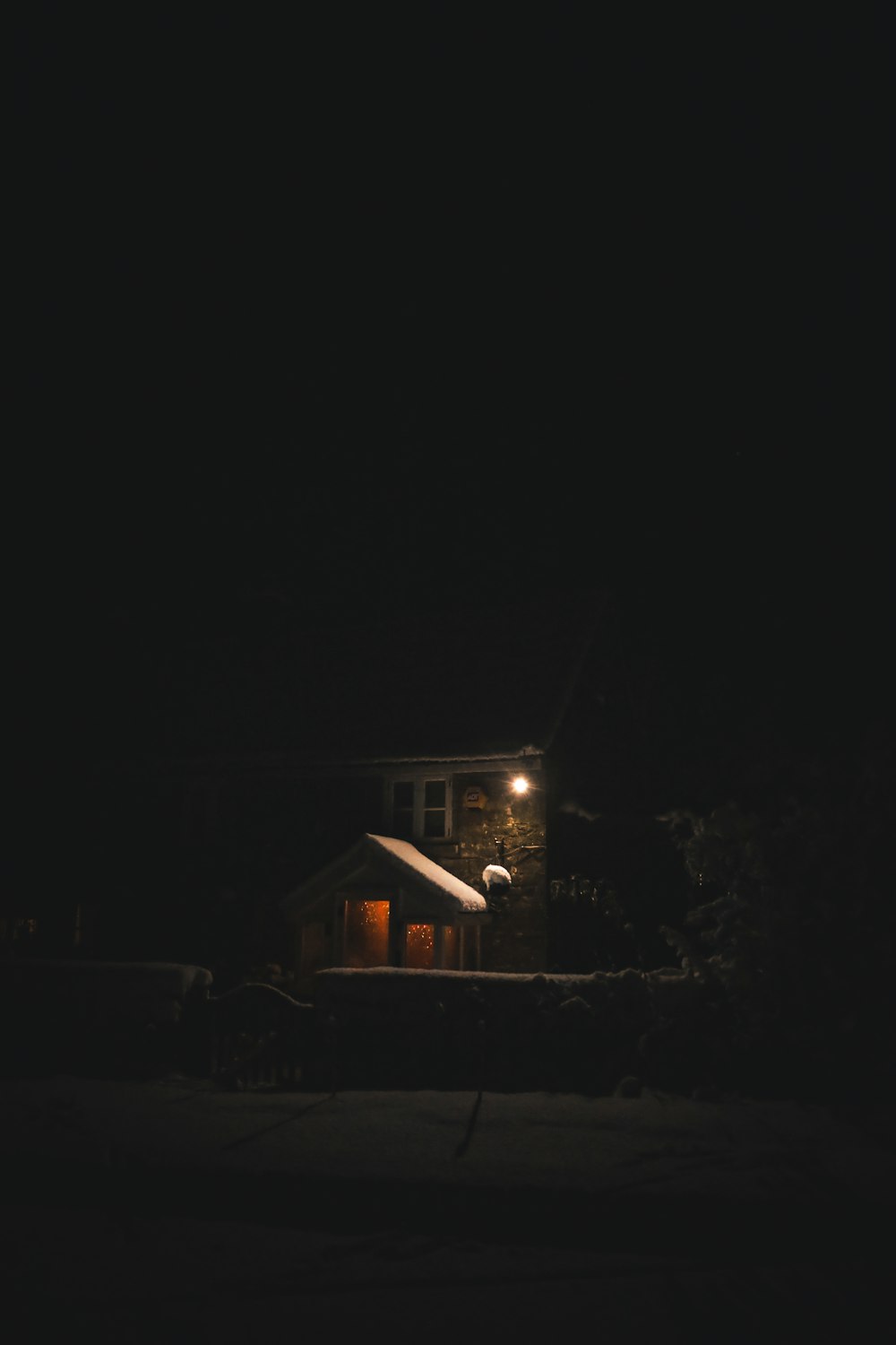 a house is lit up at night in the dark