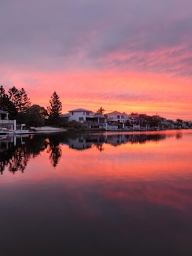 Exterior shot of a beautifully remodeled waterfront home catching the sun at sunset.