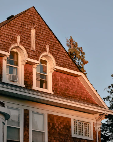 Cozy European-style house exterior bathed in warm afternoon light.
