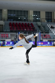 a woman is skating on an ice rink