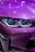 The image displays a close-up of a futuristic car's front, showcasing a vivid purple exterior with sleek, modern headlights. Reflections of ambient lights create a shiny effect on the car's surface.