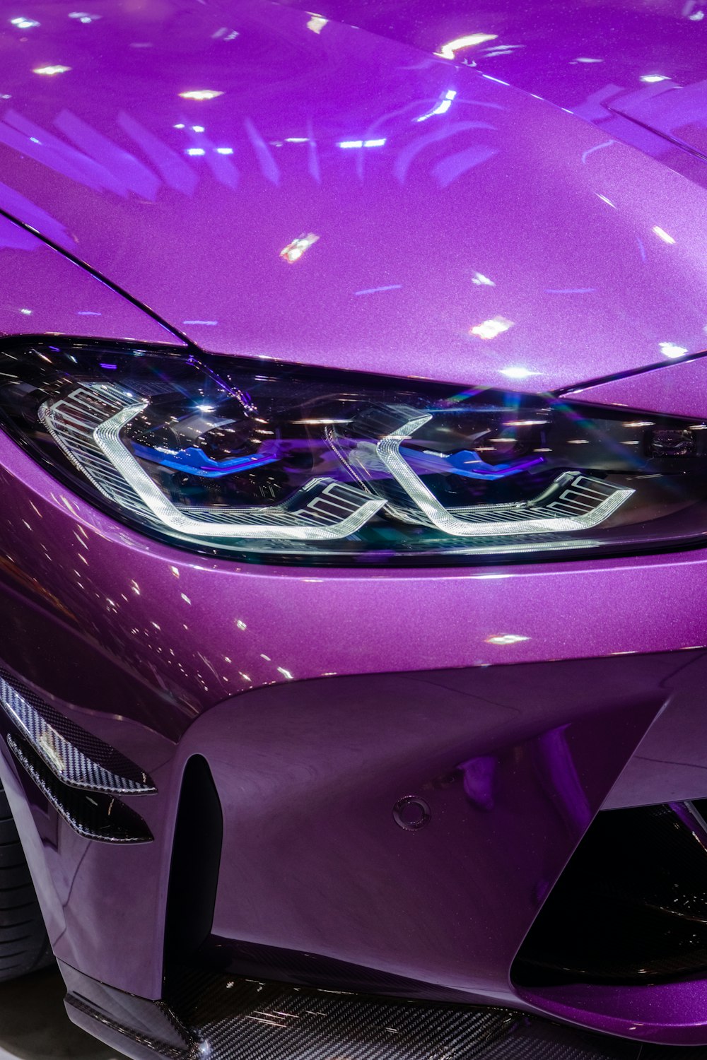 a close up of the front of a purple sports car
