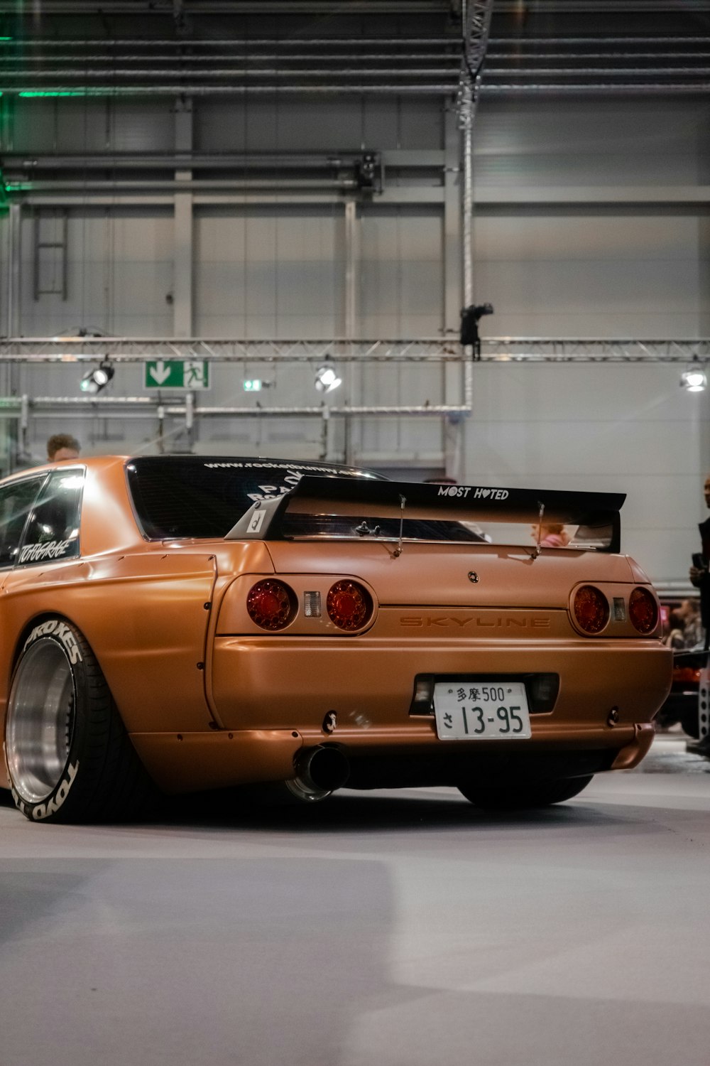 an orange sports car parked in a garage