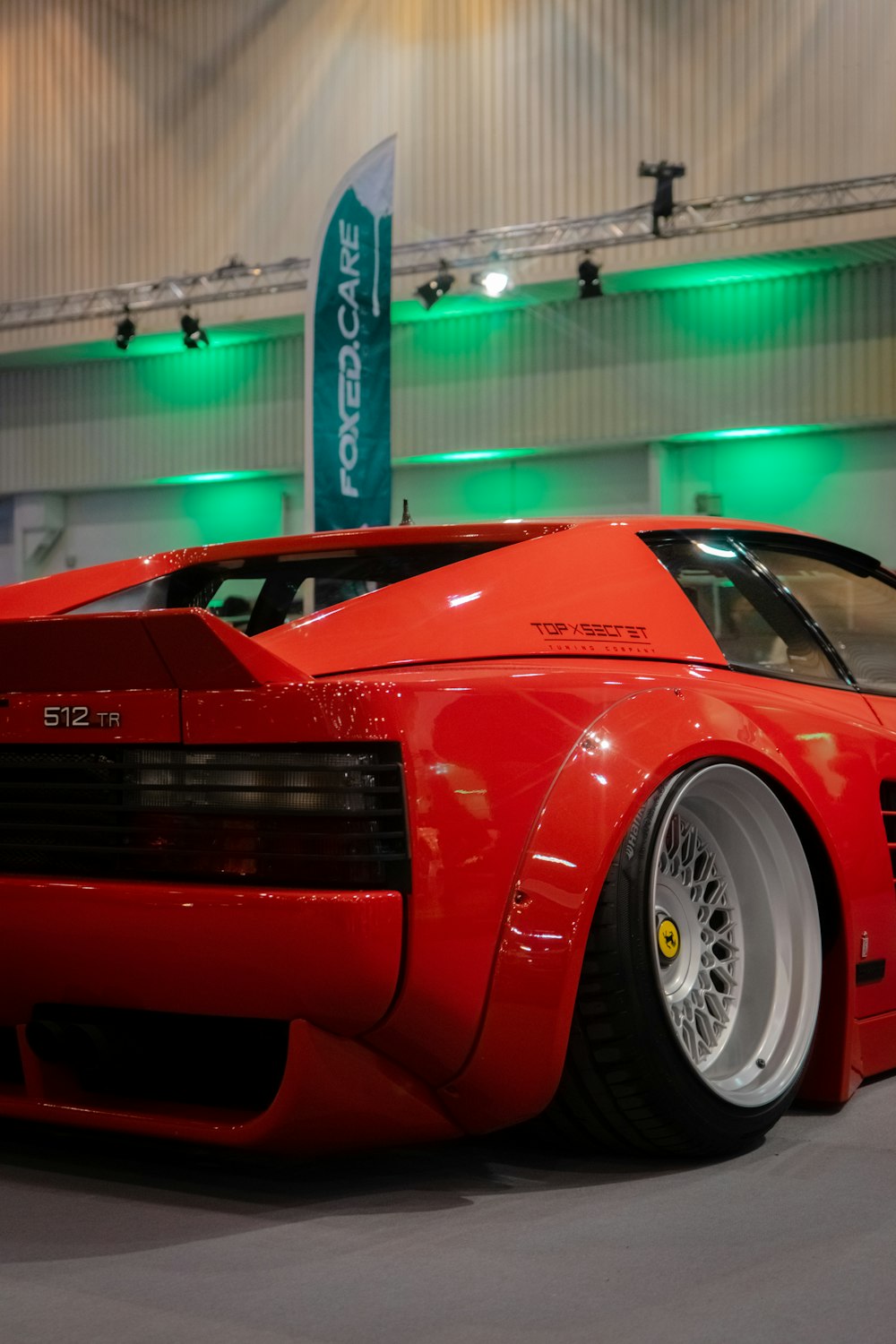 a red sports car parked inside of a building