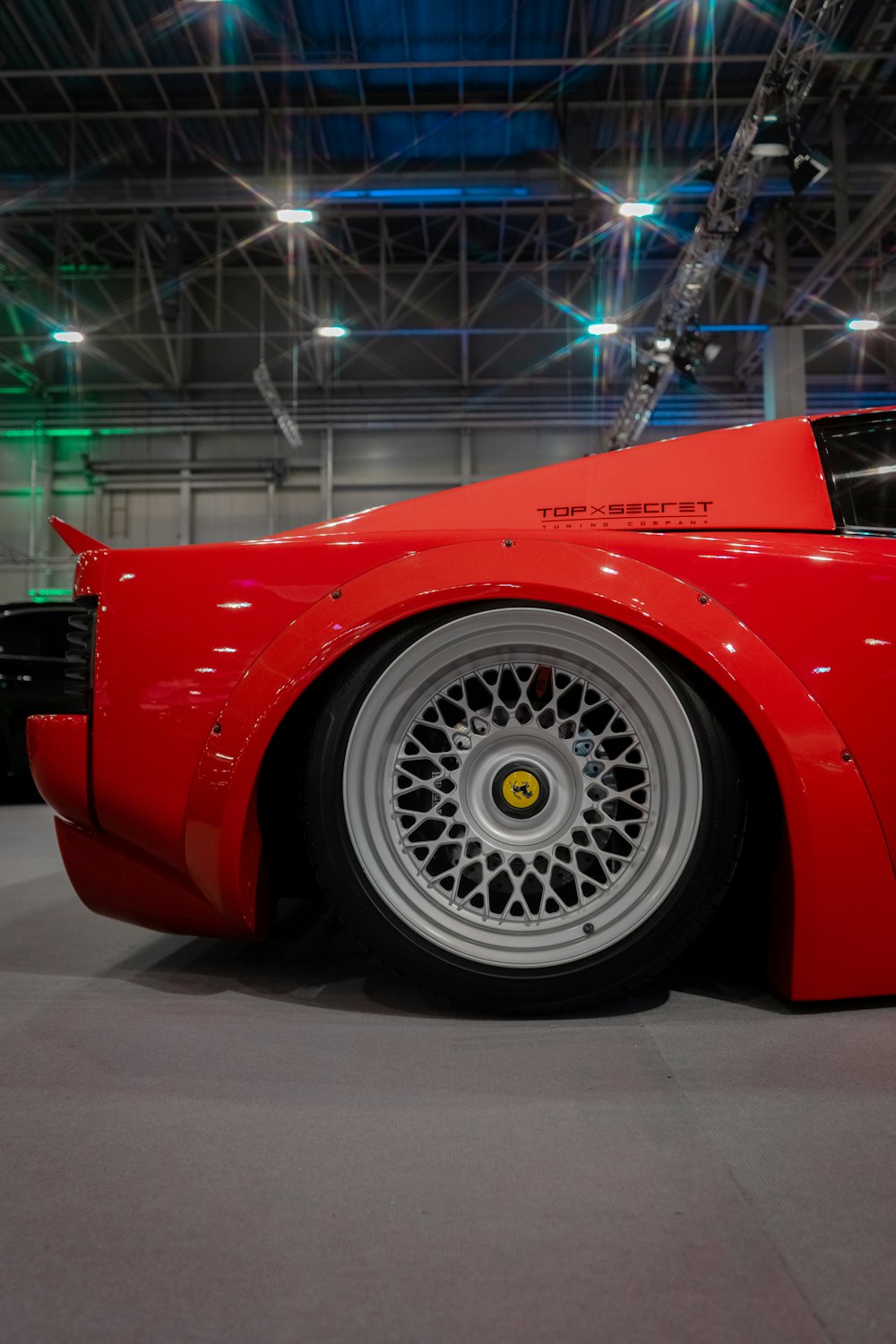 a red sports car parked inside of a building