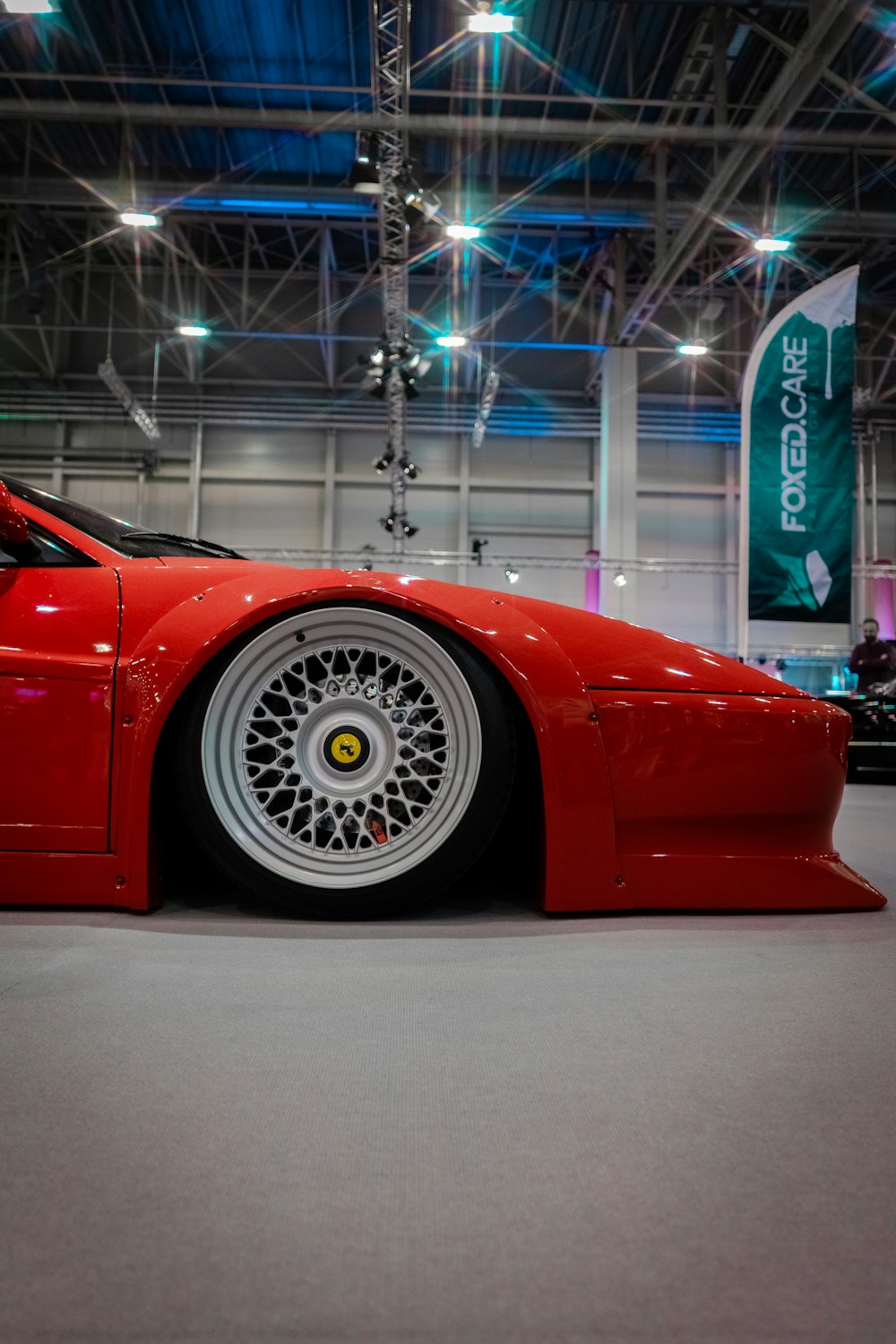 a red sports car parked inside of a building