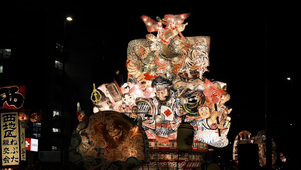 a large display of asian masks on display at night