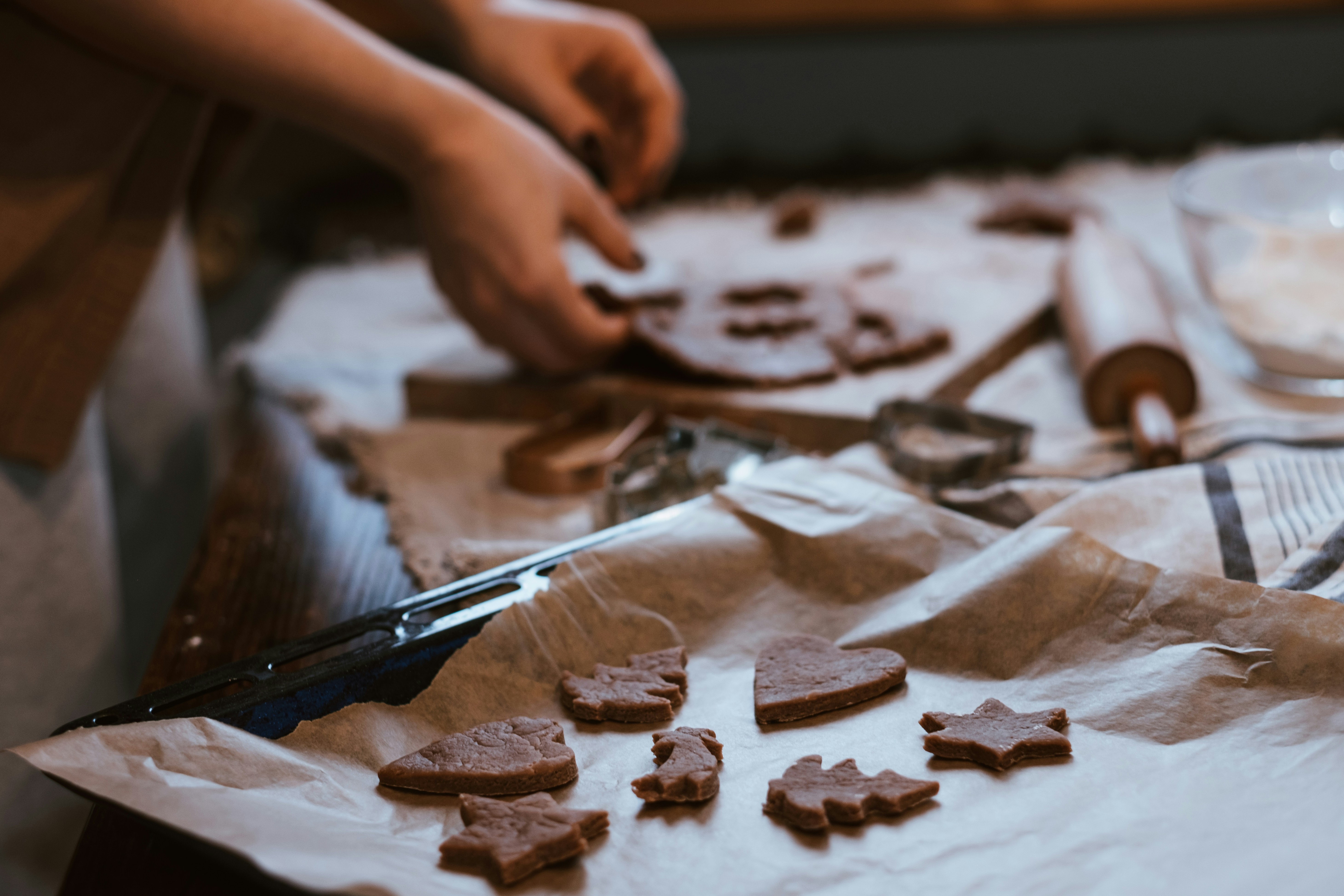 a person cutting up some cookies on a table