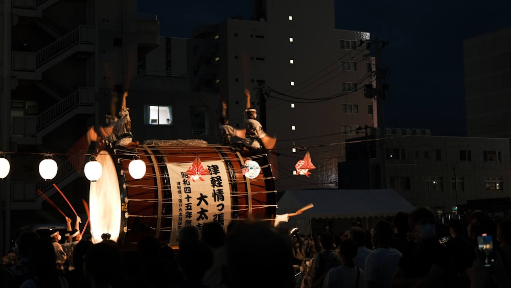 a group of people standing around a drum