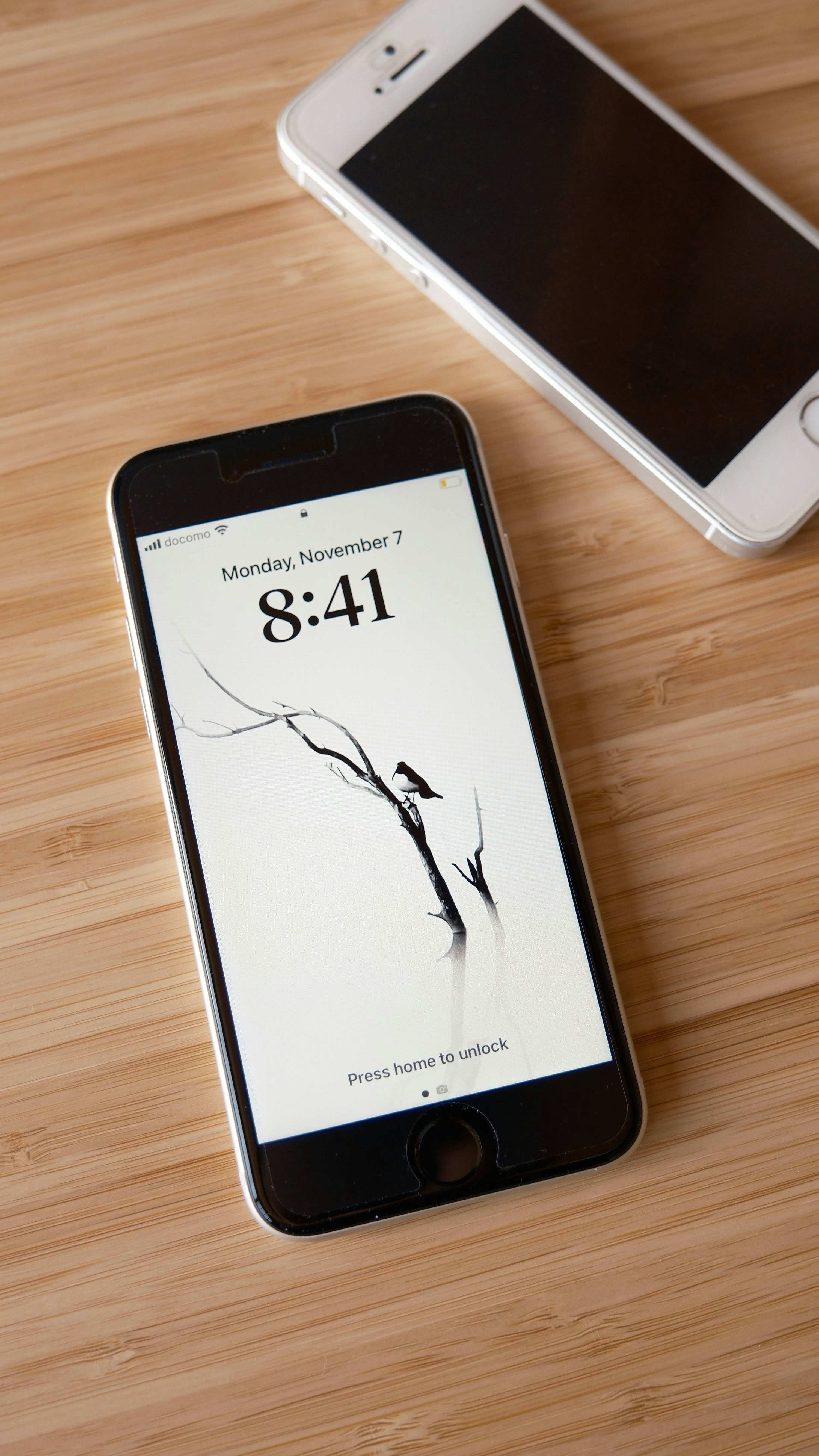 a cell phone sitting on top of a wooden table