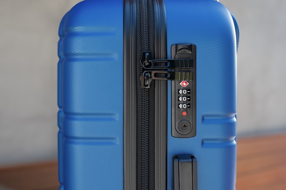 a blue piece of luggage sitting on top of a wooden table