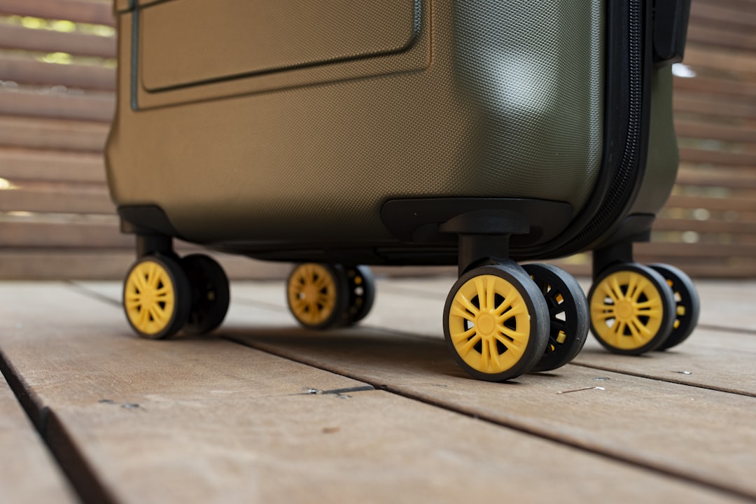 a piece of luggage sitting on top of a wooden floor, Andante airline-approved carry-on from American Green Travel (olive