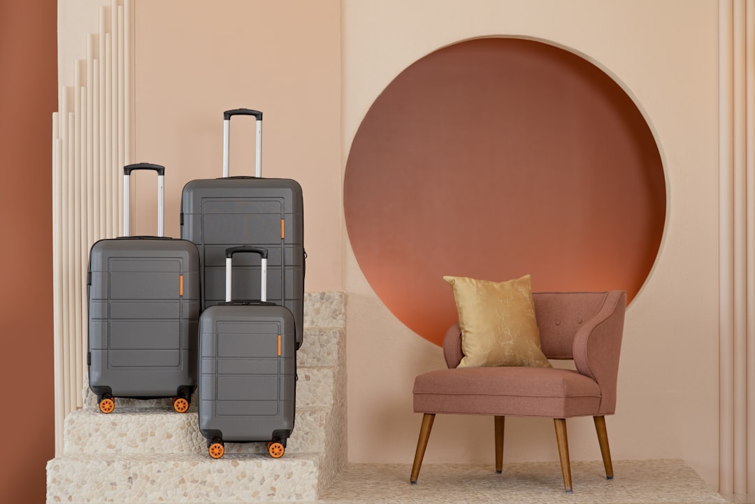 three pieces of luggage sitting on top of a chair, Andante three-piece set from American Green Travel (charcoal).