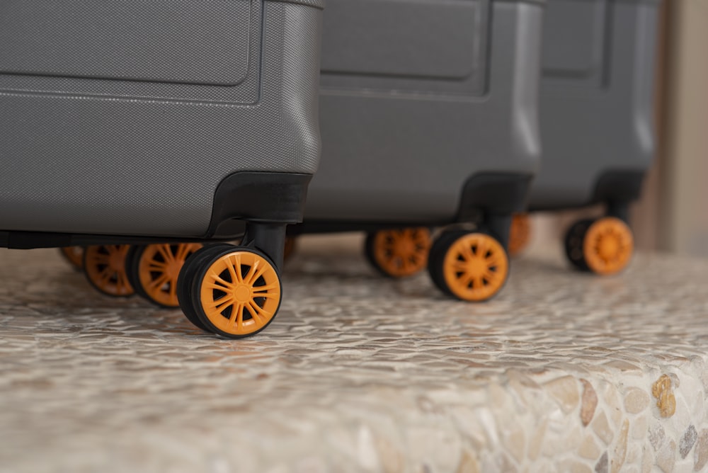 a row of suitcases with wheels on a table