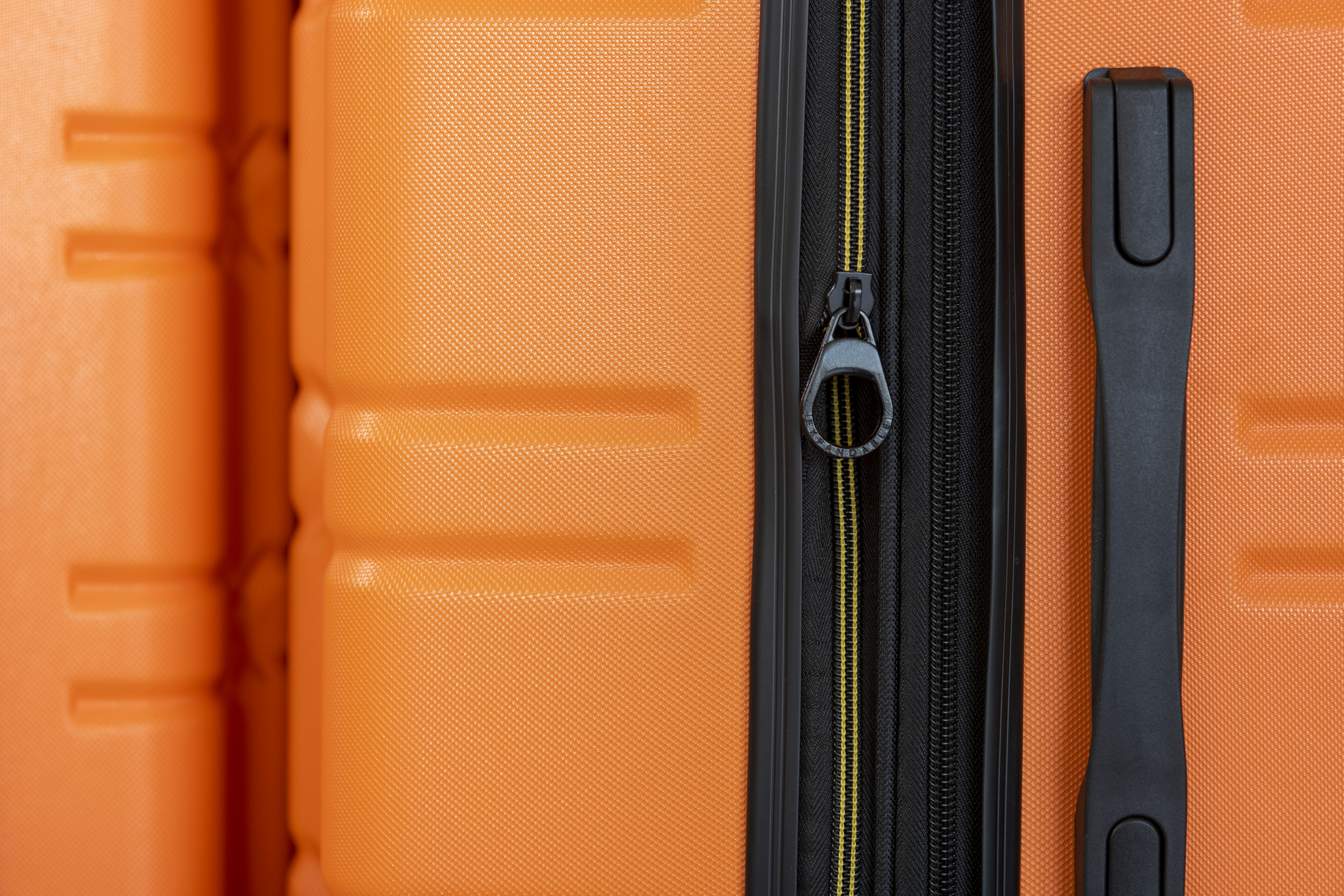 an orange piece of luggage with a black handle, Allegro three-piece set from American Green Travel (orange).