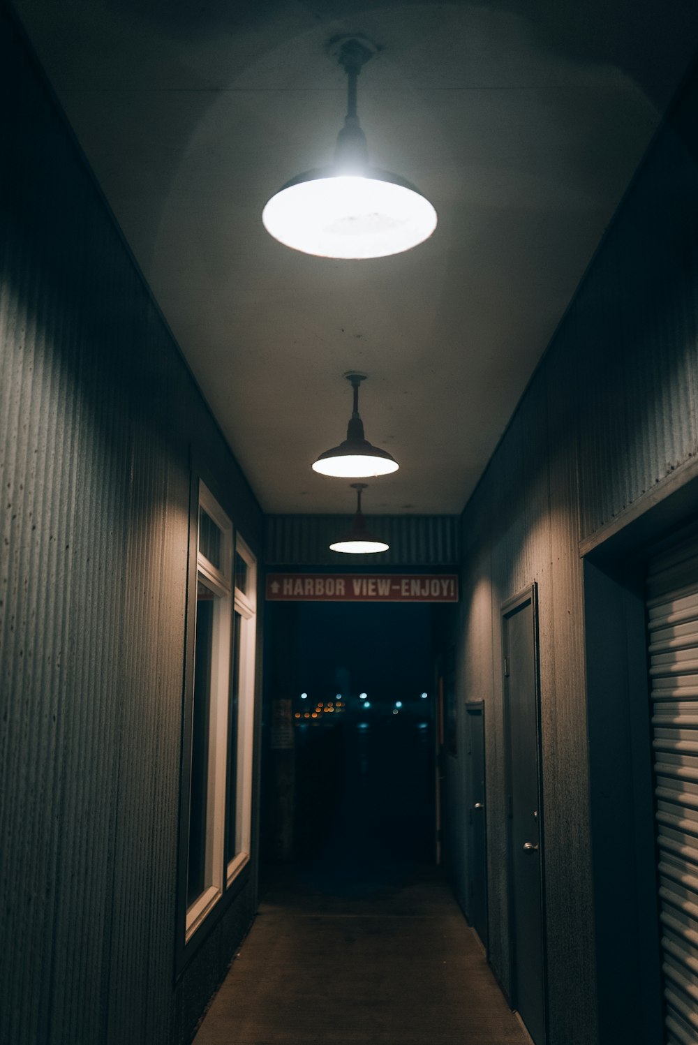 a dark hallway with a light hanging from the ceiling