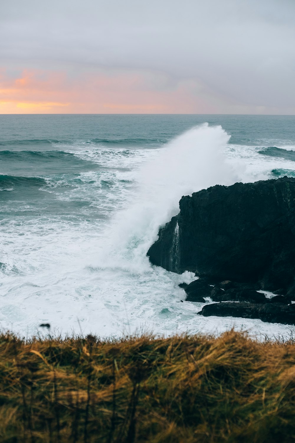 a large wave crashing into the shore of the ocean