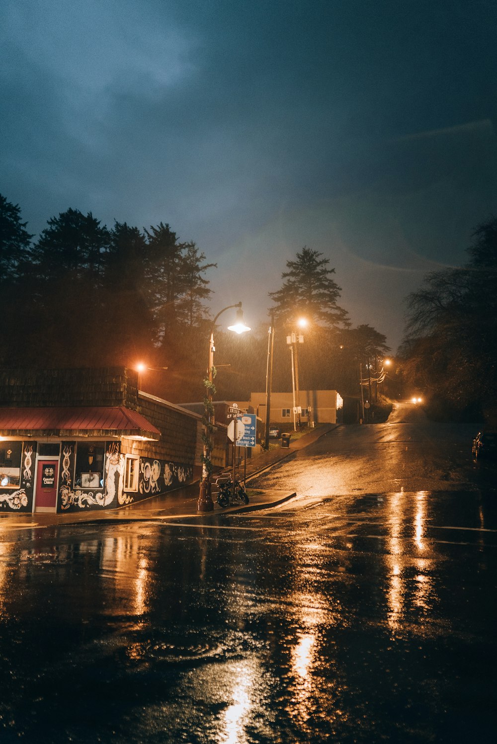 a bus is parked on the side of the road at night