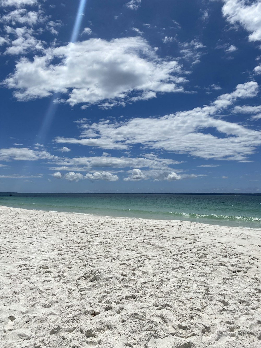 a white sandy beach under a blue sky