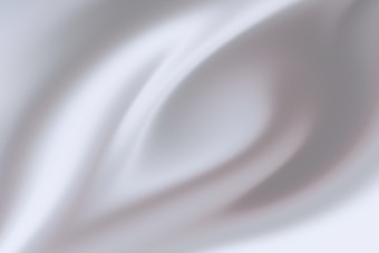 A soft, abstract pattern with smooth, flowing lines and gradients, creating a sense of movement or fluidity. The image features gentle curves and a mix of light and shadow that give it a serene and calming quality.