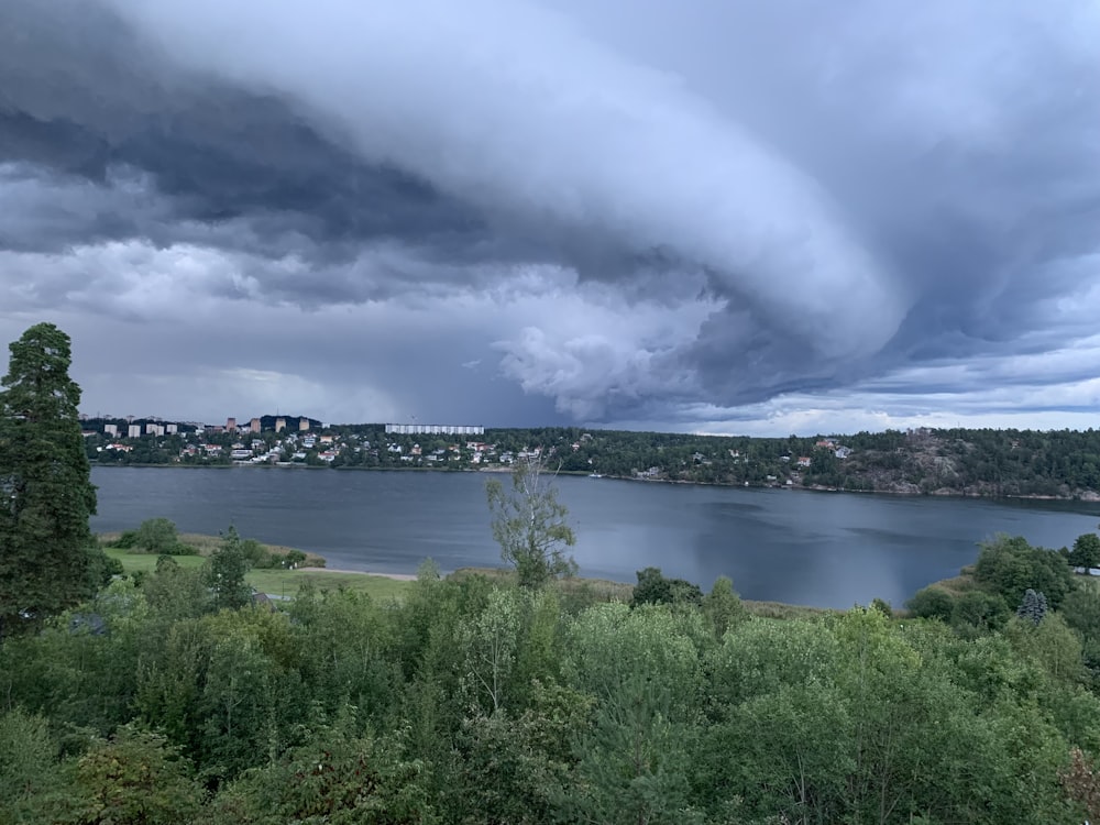 a large storm is coming over a lake