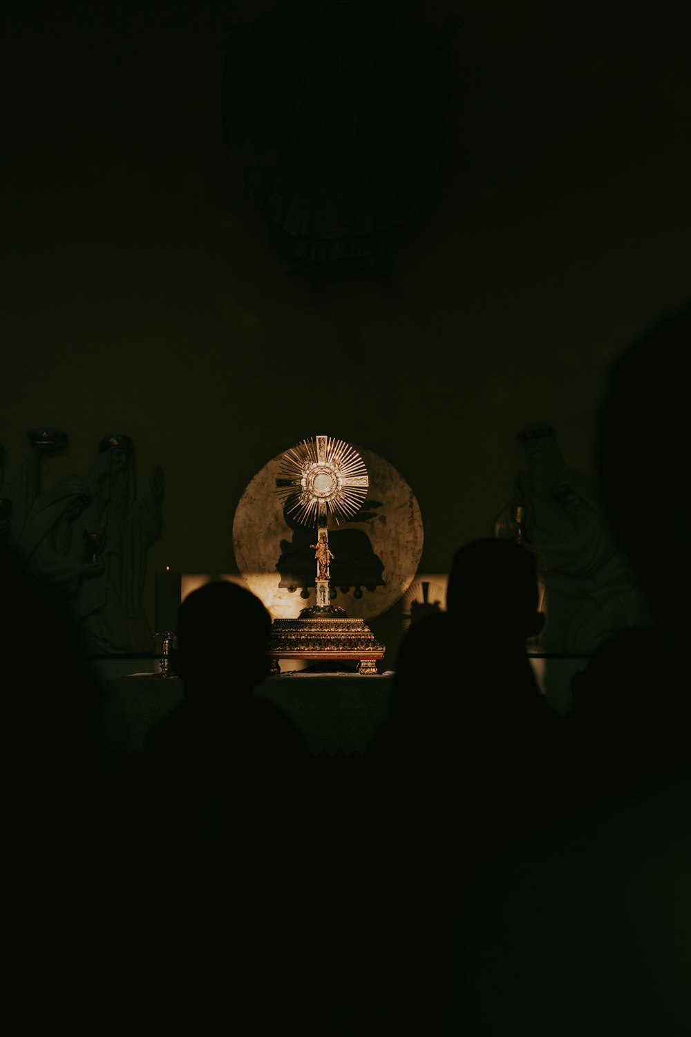 a group of people sitting in a dark room