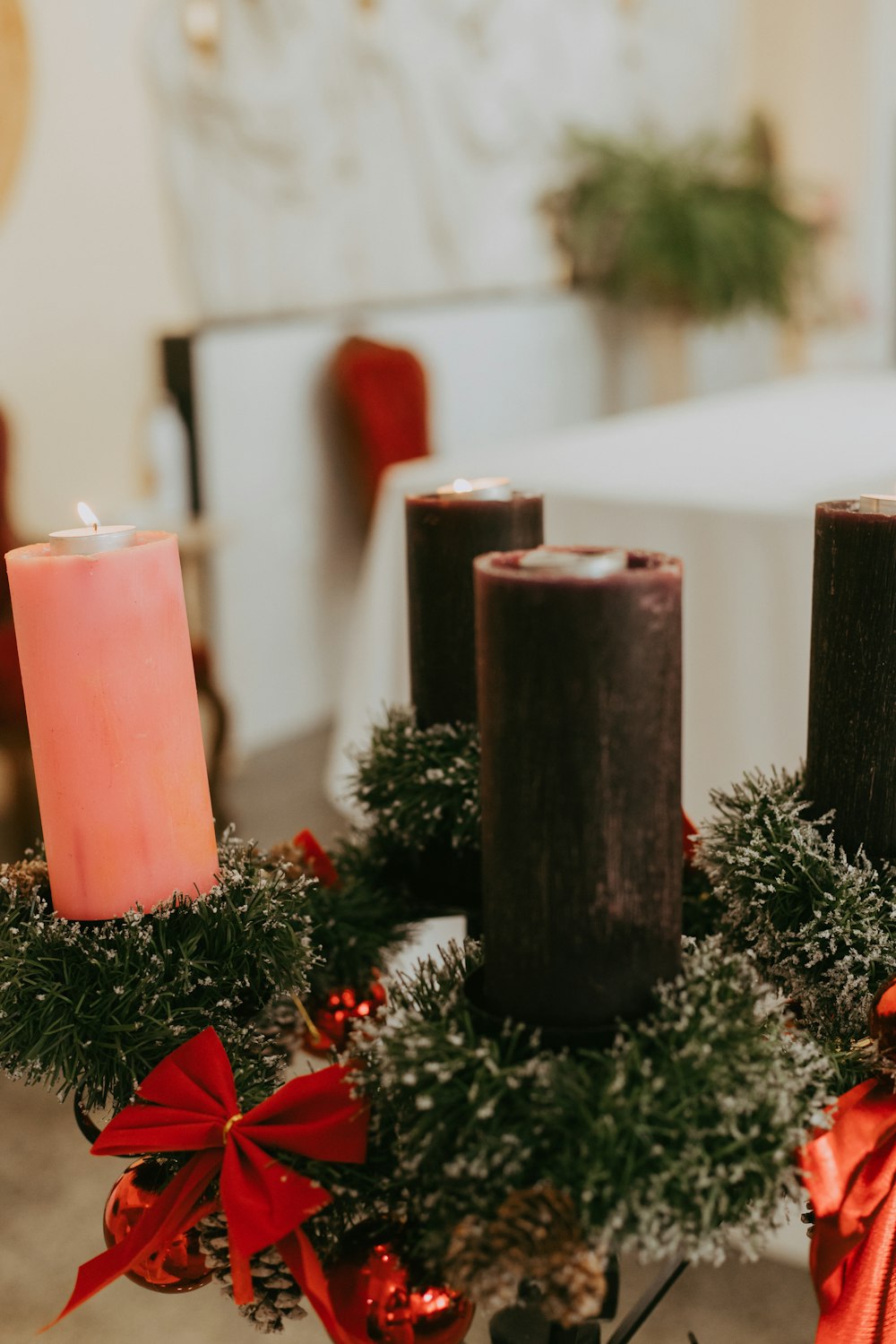 a table topped with candles and wreaths on top of it