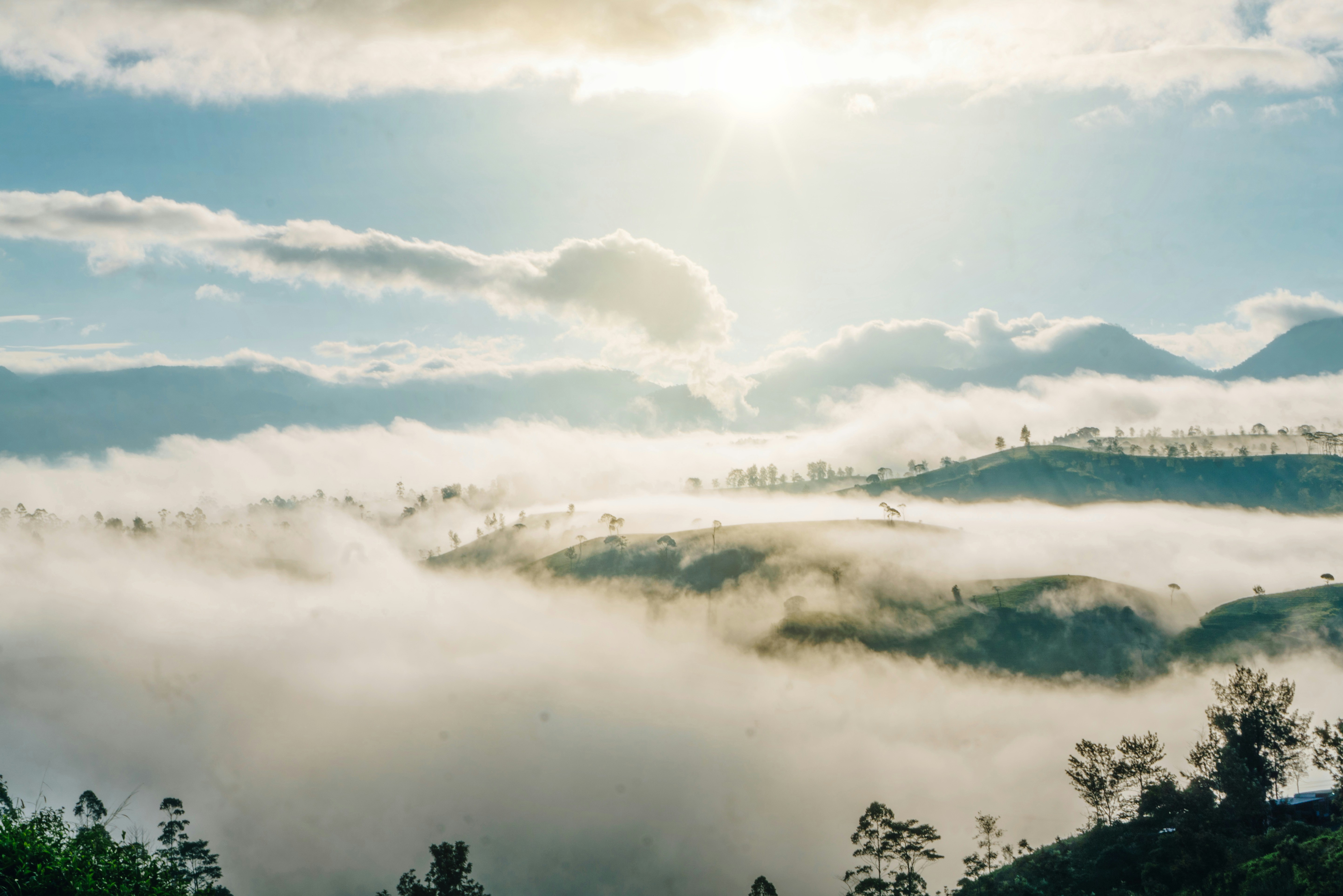 the sun shines through the clouds in the mountains