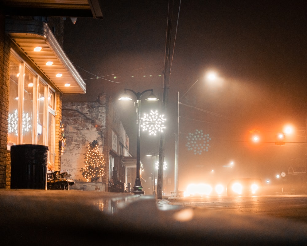 a street light on a foggy street at night
